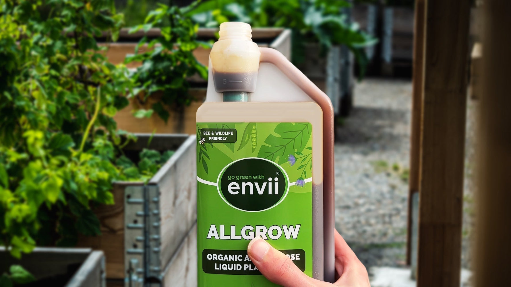 holding Allgrow infront of garden