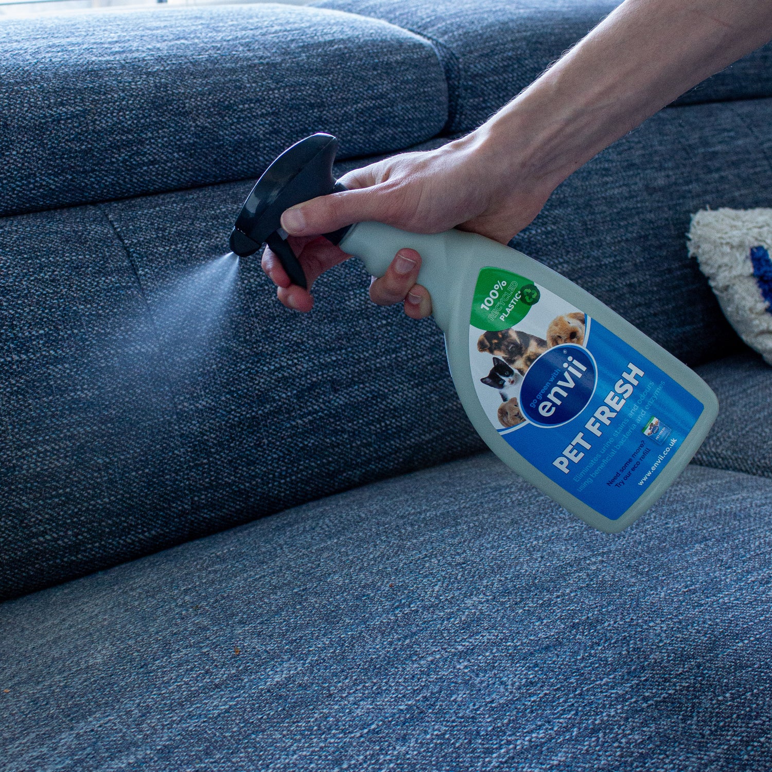 Spraying Pet Fresh onto a sofa