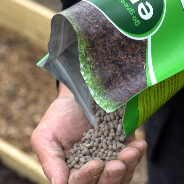 Activearth lifestyle pouring pellets into hand.